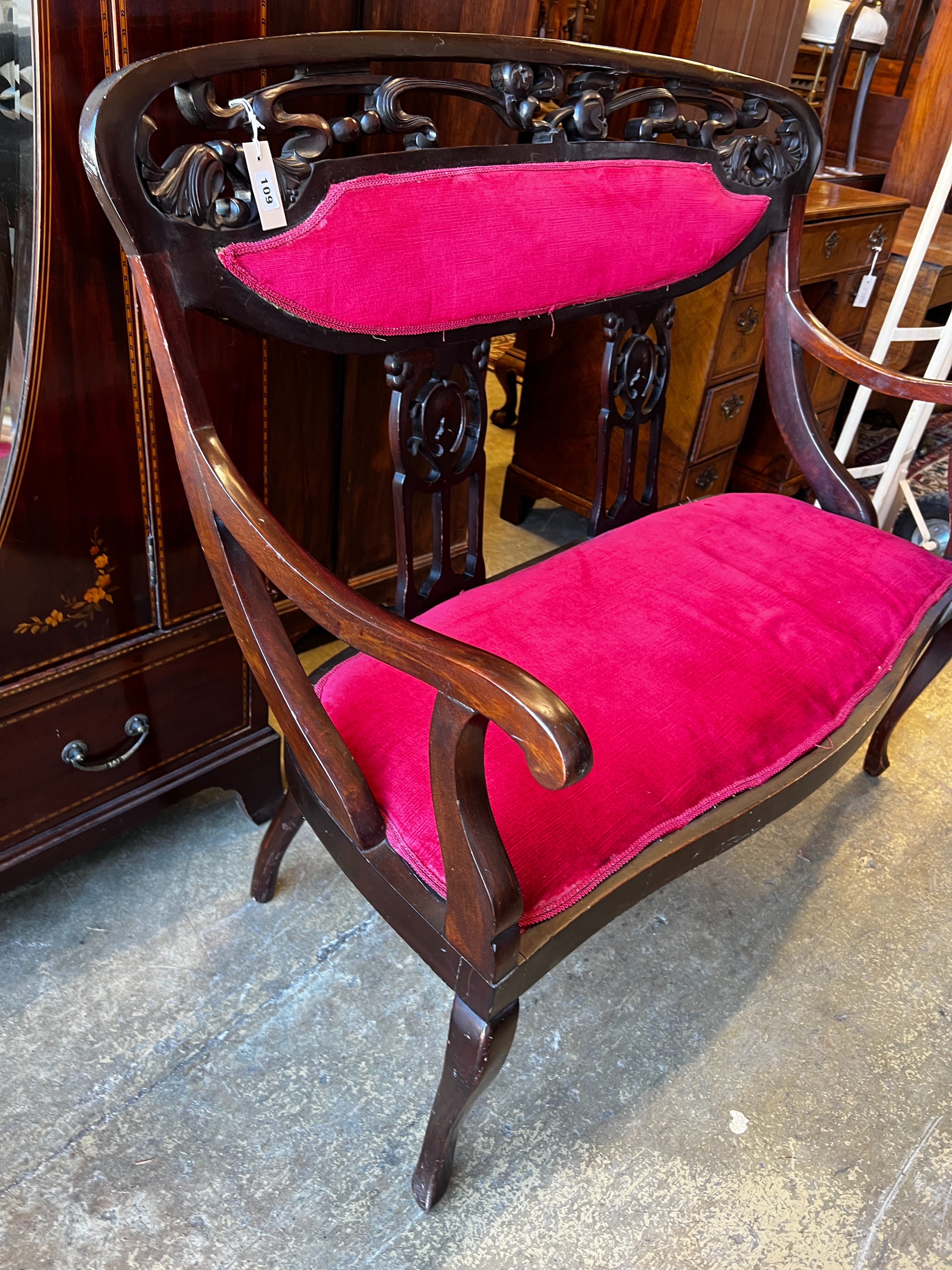 A late Victorian Art Nouveau mahogany upholstered salon settee, length 112cm, depth 50cm, height 106cm